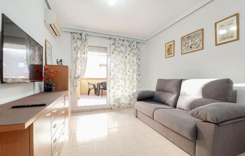 a living room with a couch and a table at 2 Bedroom Nice Apartment In Oropesa Del Mar in Oropesa del Mar