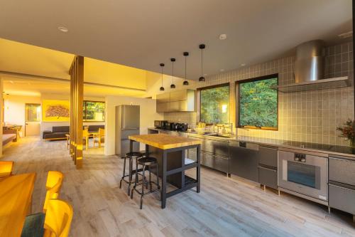 a kitchen with a island in the middle of a room at Sakura in Nozawa Onsen