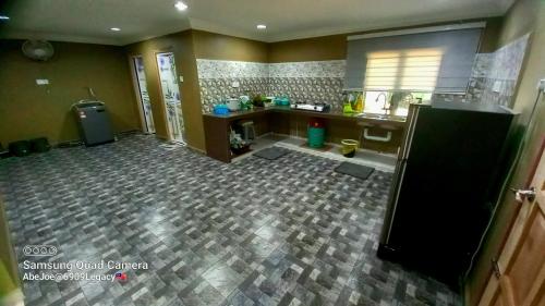 an empty kitchen with a counter and aifting at Homestay Pasir Mas Tok Ma in Pasir Mas