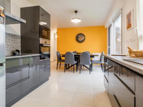 une cuisine et une salle à manger avec une table et des chaises dans l'établissement Maison familiale calme, à 5 km des plages, jardin clos, garage, wifi, proche Guérande et La Baule - FR-1-306-1264, à Assérac