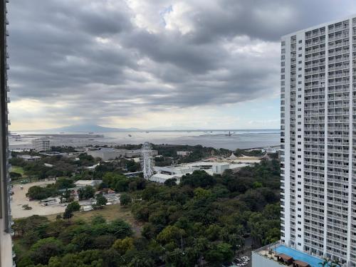 an aerial view of a city with a tall building at SMDC Coast Residences in Manila