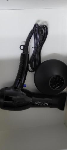 a black hair dryer sitting on a table at Smart Stylish Downtown Condo- 2 bedrooms in Saskatoon