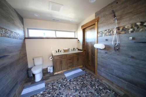 a bathroom with a toilet and a sink and a shower at Mount Jumbo Lookout in Missoula