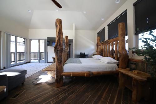 a bedroom with a bed made out of logs at Mount Jumbo Lookout in Missoula