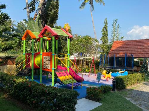 a playground with a slide in a park at Samui Green Life in Bophut 