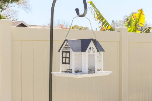 a toy house hanging on a fence at Snook Haven - Hot Tub, Pool, Minigolf, Dog Space in Largo