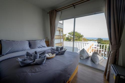 a bedroom with a bed with two baskets on it at Le soleil koh Larn in Ko Larn