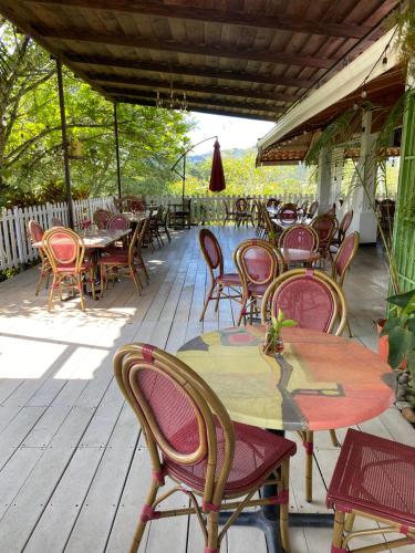 a group of tables and chairs on a wooden deck at Jicote finca de ecoturismo in Cartago