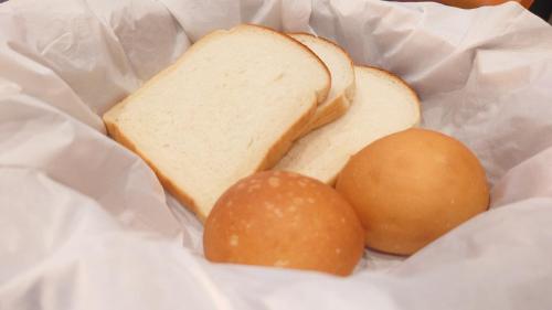 a sandwich and two eggs in a basket at Tabist Annex Hotel Tetora Hakodate in Hakodate