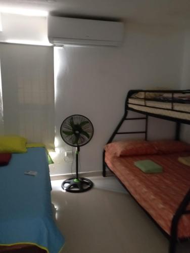a room with two bunk beds and a fan at Atardeceres Puntarenas in Puntarenas