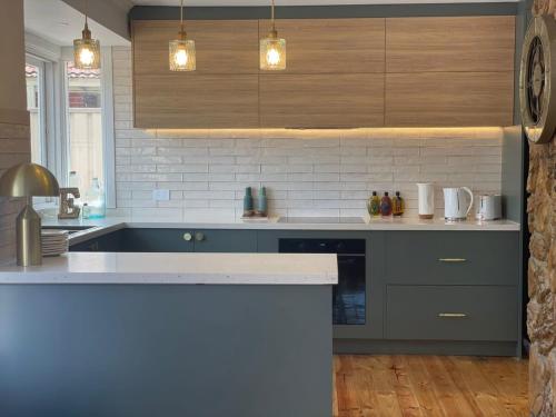 a kitchen with a sink and a counter top at Evies White House Oasis I Pool & Close to Airport in Melbourne