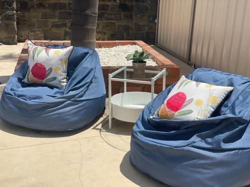 two blue bean bags with pillows on a patio at Evies White House Oasis I Pool & Close to Airport in Melbourne