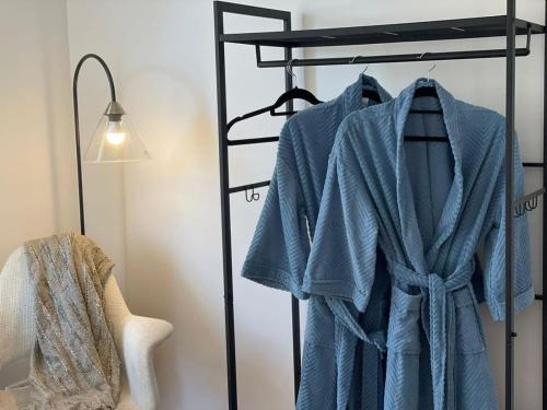 a robe on a rack in a room with a lamp at Evies White House Oasis I Pool & Close to Airport in Melbourne