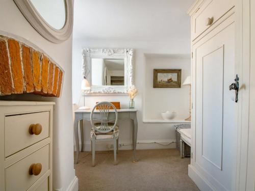 a room with a desk with a chair and a mirror at Rose Cottage in Stoke Gabriel