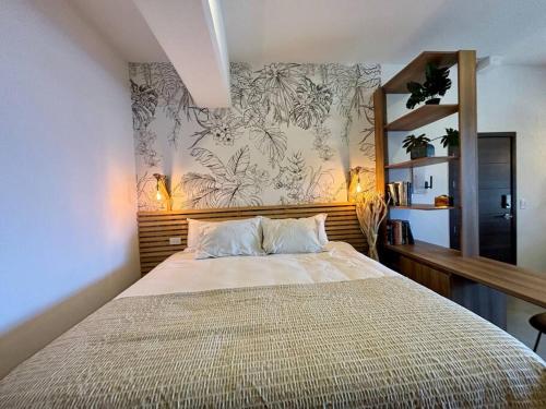 a bedroom with a large bed with a floral wallpaper at Tropical Apartment in the city in Guatemala