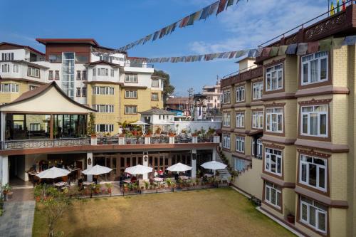 an overhead view of a building with tables and umbrellas at Shambaling Boutique Hotel in Kathmandu