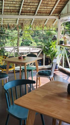 a group of tables and chairs in a restaurant at Easy Life Koh Chang in Ko Chang
