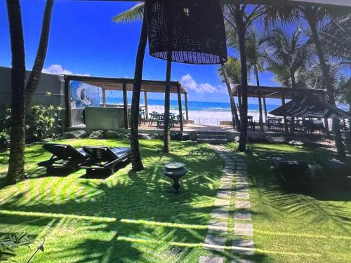a lawn with a view of the beach and the ocean at BK Beach Boutique Hotel - Hikkaduwa in Hikkaduwa