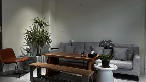 a living room with a couch and a table at 飛行船電梯民宿 in Taitung City