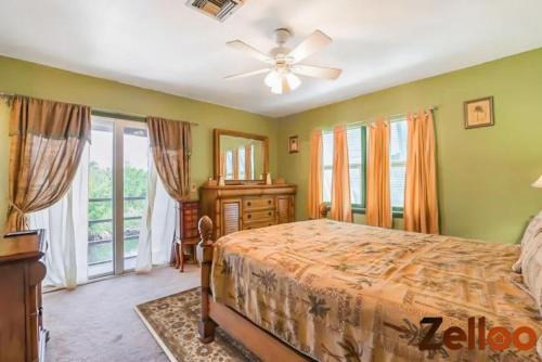 a bedroom with a bed and a ceiling fan at Experience Coastal Living at its Best Florida Keys in Summerland Key