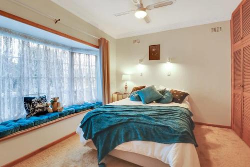 a bedroom with a bed and a large window at GATSBY walk to Geelong CBD and Waterfront in Geelong
