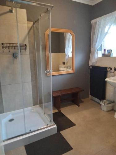 a bathroom with a shower and a sink at Howick Greendale 4 Self Catering Units Solar & Battery Back-Up in Howick