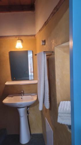 a bathroom with a sink and a mirror at Fournos Aroniadika in Kythira