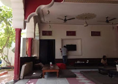 a living room with a man standing in a room at Hotel Third Eye in Pushkar