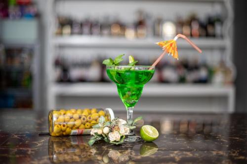 a green drink in a martini glass on a table at Eldorado Rustic Hotel in Nakuru