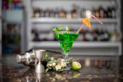 a green drink in a martini glass on a counter at Eldorado Rustic Hotel in Nakuru