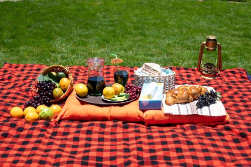 a picnic blanket with a plate of fruit on it at Eldorado Rustic Hotel in Nakuru