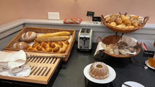 a bunch of different types of bread and pastries at Sorell Hotel Tamina - Garni in Bad Ragaz