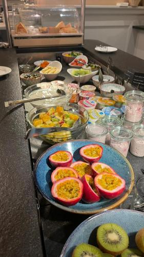 a buffet of food with fruit on a table at Sorell Hotel Tamina - Garni in Bad Ragaz