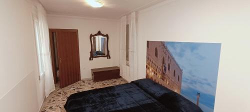 a bedroom with a bed and a mirror on the wall at My Rialto Palace in Venice