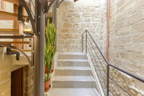 a staircase in a building with a brick wall at Rb42 - Charming & Historic House in Rabat