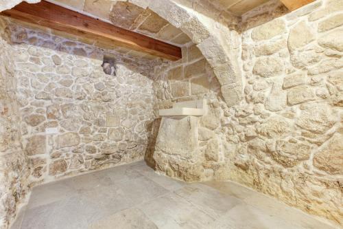 a stone room with a stone wall at Rb42 - Charming & Historic House in Rabat