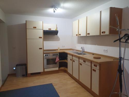 a kitchen with a white refrigerator and a sink at Ferienwohnung Tammer Allee in Tamm