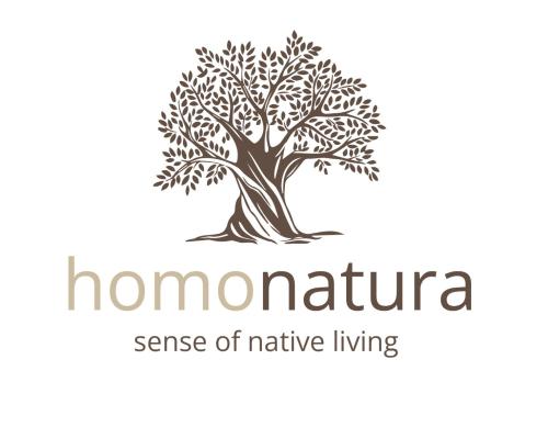a logo of a tree with the words nomura sense of native living at homonatura petrinum in Ariokhórion