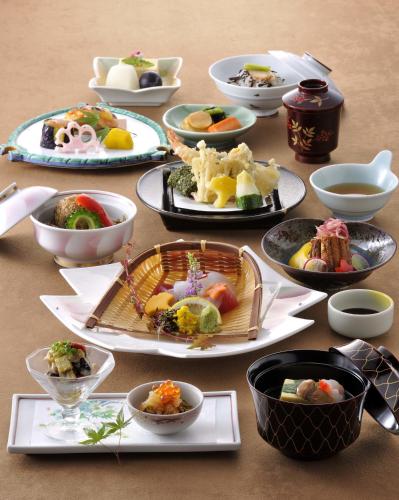 a table with many plates of food on it at Kagoshima Sun Royal Hotel in Kagoshima