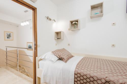 a bedroom with a bed and a mirror at Apartman Mija in Split