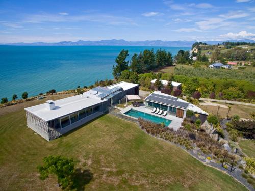 an aerial view of a house with a swimming pool at Kina Retreat - Luxury Nelson Getaway in Tasman