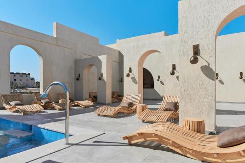 a resort with chairs and a swimming pool at True Beach Resort in Marsa Alam City