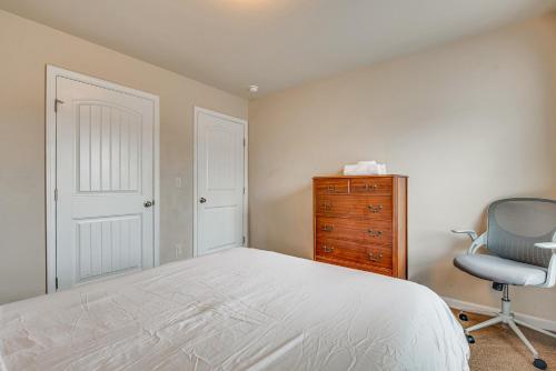 a bedroom with a bed and a chair and a dresser at Spacious Atlanta Home with Yard and Charcoal Grill! in Atlanta
