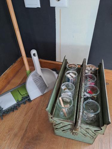 a tray of cups on a wooden floor with a tool at SaberAmar City & Ria & More in Aveiro