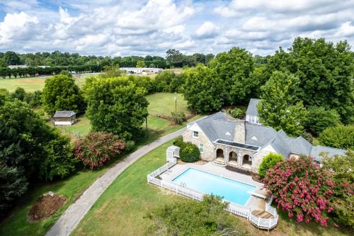 an aerial view of a house with a swimming pool at Tranquil Mountain Escape Luxurious 5-Bedroom Farmhouse with Pool in Maryville