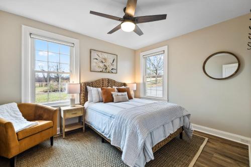 a bedroom with a bed and a ceiling fan at Tranquil Mountain Escape Luxurious 5-Bedroom Farmhouse with Pool in Maryville