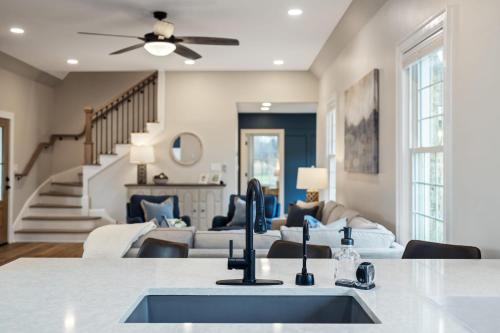 a kitchen with a sink and a living room at Tranquil Mountain Escape Luxurious 5-Bedroom Farmhouse with Pool in Maryville