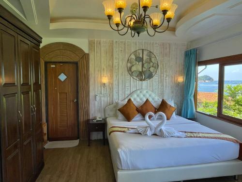 a bedroom with a bed with a bow on it at DD Hut Koh Tao in Koh Tao