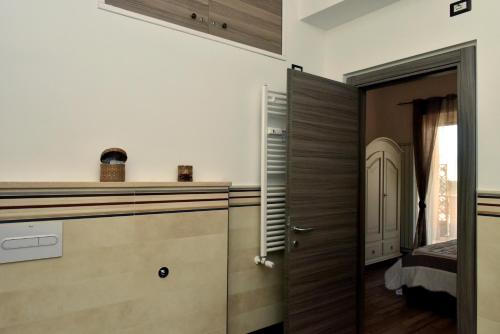 a kitchen with wooden cabinets and a door at In Terrazza Da Giusy in Rome