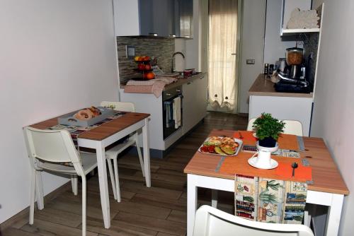 a small kitchen with a table and a table and chairs at In Terrazza Da Giusy in Rome